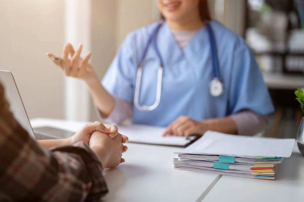 Doctor and patient discussing medical files.