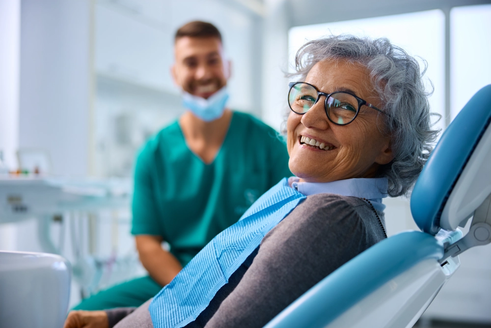 Smiling woman in dentist chair.