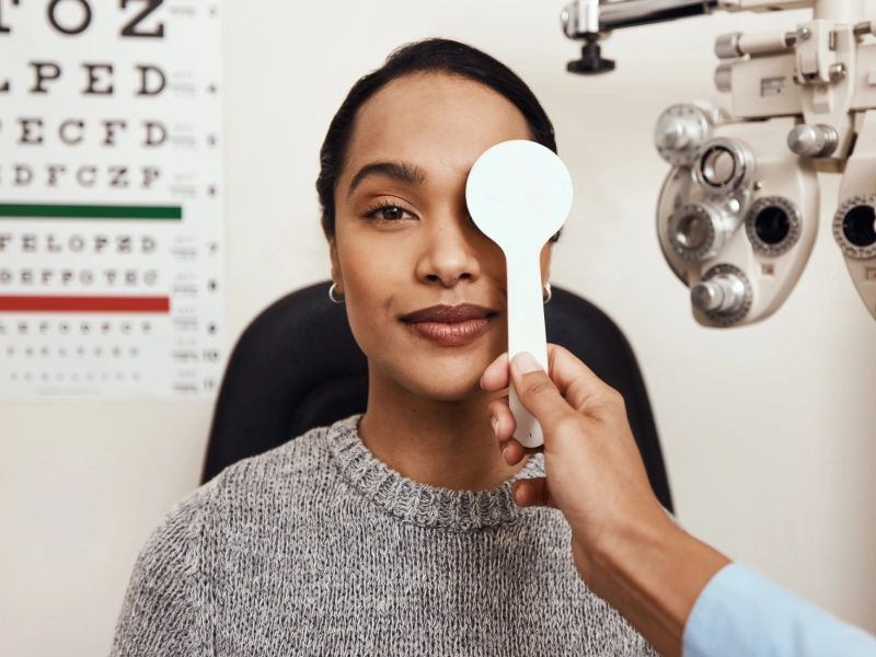 Woman getting her eyes examined at the optometrist.