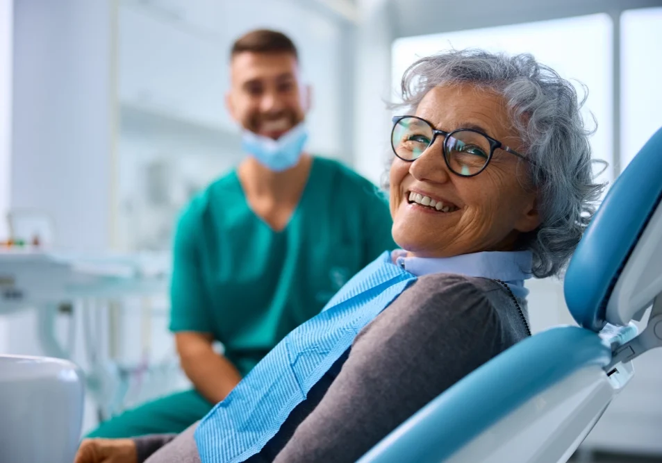 Smiling woman in dentist chair.